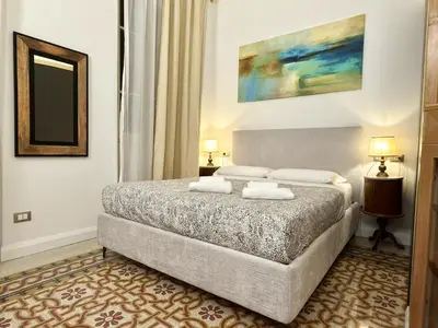 a bedroom with a bed with two pillows on it at Monti Lovely Suite in Rome