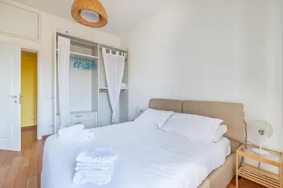 a bedroom with a white bed with towels on it at Emanuele Filiberto - Vivora Srl in Rome