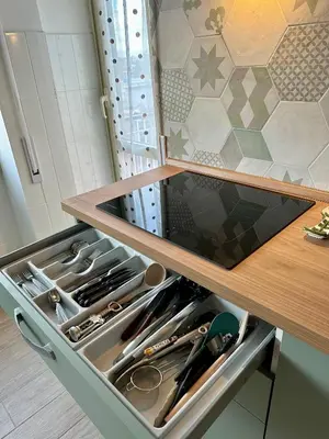 a drawer in a cabinet filled with utensils at Monti Tiburtini Roma Guest House Apartment in Rome