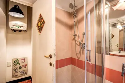 a bathroom with a shower with a glass door at Home-In-Rome in Rome