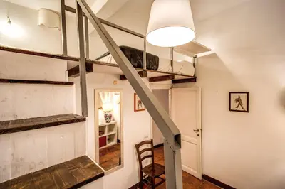 a staircase in a room with a loft at Home-In-Rome in Rome
