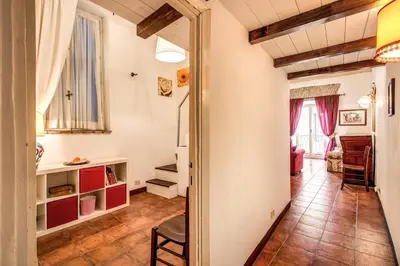 a room with a hallway with a table and chairs at Home-In-Rome in Rome