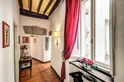 a room with a red curtain and a window at Home-In-Rome in Rome