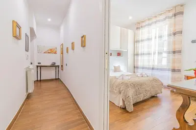 a bedroom with a bed and a large window at Home relax San Lorenzo in Rome