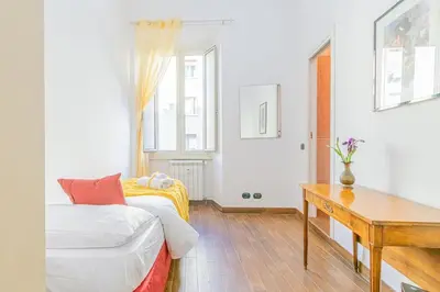 a white room with a bed and a desk at Home relax San Lorenzo in Rome