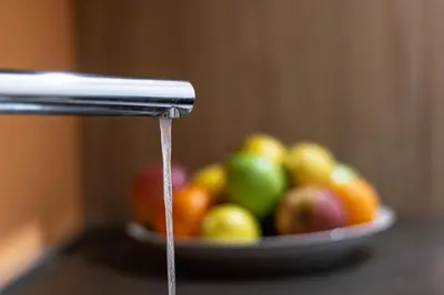 a stream of water coming out of a holder with a bowl of fruit at Home relax San Lorenzo in Rome