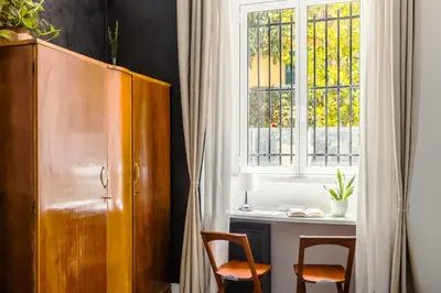 a room with two chairs and a desk and a window at Br1tannia 36 in Rome