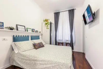 a bedroom with a bed and a flat screen tv at Br1tannia 36 in Rome