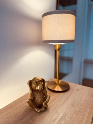 a small toy frog sitting on a table next to a lamp at Casa Umbertina in Rome