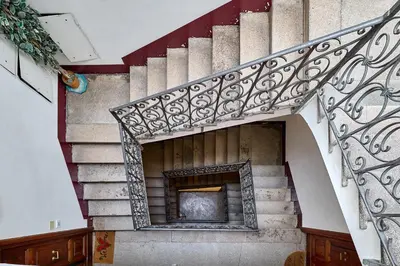a stairway with a fireplace in a building at SweetgardenTrastevere in Rome