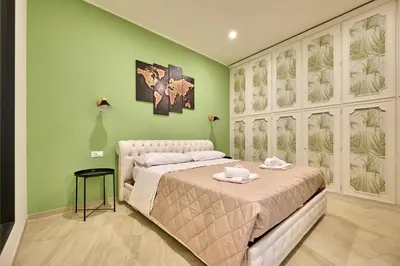 a bedroom with a bed in a room with green walls at SweetgardenTrastevere in Rome