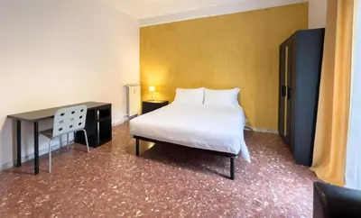 a bedroom with a white bed and a desk at Vintage Charm & Comfort - Garbatella in Rome