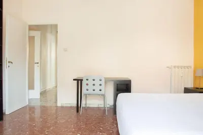 a table and a chair in a room at Vintage Charm & Comfort - Garbatella in Rome