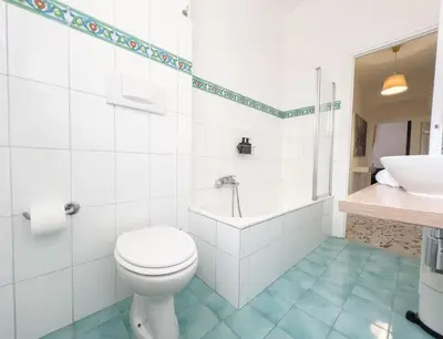 a bathroom with a toilet and a tub and a sink at Vintage Charm & Comfort - Garbatella in Rome