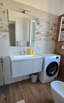 a bathroom with a washing machine and a sink at Duck House Gemelli in Rome