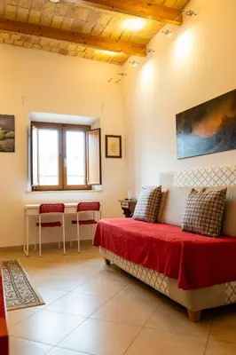 a bedroom with a bed and a table and chairs at kis inn affitacamere guesthouse in Rome
