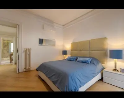 a bedroom with a large bed in a white room at Rome Luxury House 5stars in Rome