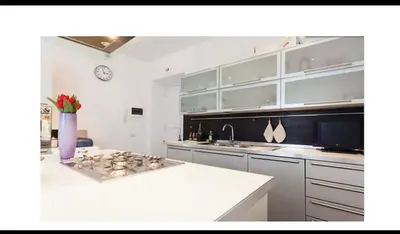 a kitchen with a white counter top and a clock at Rome Luxury House 5stars in Rome