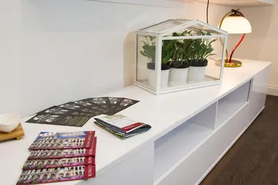 a white desk with plants in a glass box at Nido all'Aventino in Rome