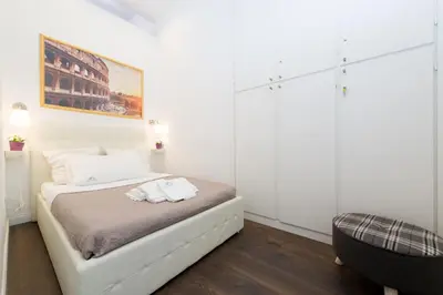 a white bedroom with a bed with white pillows at Nido all'Aventino in Rome