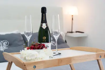 a bottle of champagne and two wine glasses on a table at Nido all'Aventino in Rome