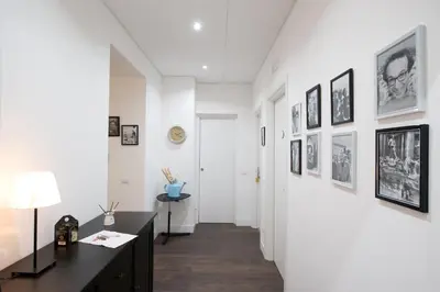 a hallway with a desk and pictures on the walls at Nido all'Aventino in Rome