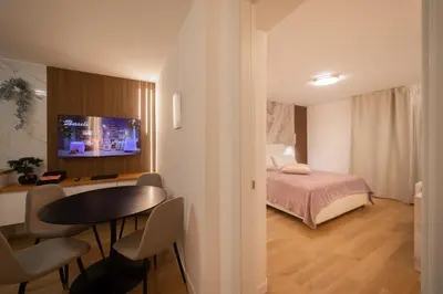 a bedroom with a bed and a table and chairs at Vivi Roma in Rome