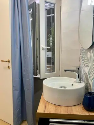 a bathroom with a white sink and a window at Vivi Roma in Rome