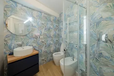 a bathroom with a shower and a sink and a mirror at Vivi Roma in Rome