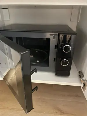 a microwave oven sitting on a shelf in a kitchen at Vivi Roma in Rome