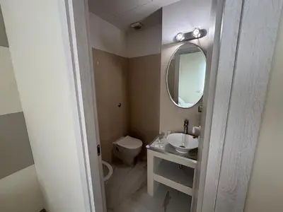 a bathroom with a sink and a mirror and a toilet at Roma Palace Suite in Rome