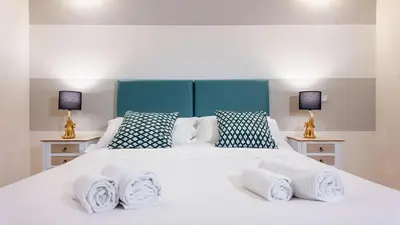 a bedroom with a large white bed with towels on it at Roma Palace Suite in Rome