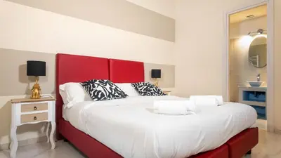 a large bed with a red headboard in a room at Roma Palace Suite in Rome
