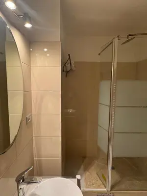 a bathroom with a glass shower and a sink at Roma Palace Suite in Rome