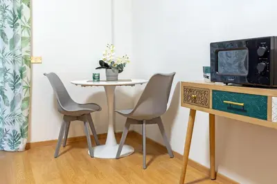 a table with two chairs and a table with a tv at Renè home - Ponte Milvio in Rome