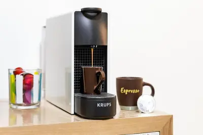 a coffee maker on a wooden shelf with two cups at Renè home - Ponte Milvio in Rome