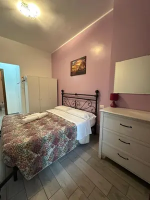 a small bedroom with a bed and a dresser at Lovely flat next to vatican - private entrance in Rome