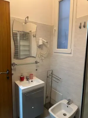 a bathroom with a sink and a mirror and a toilet at Lovely flat next to vatican - private entrance in Rome