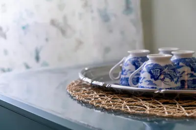 four blue and white vases on a plate on a table at Elegantis La ParioLina Apartment in Rome