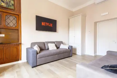 a living room with a couch and a tv at Elegantis La ParioLina Apartment in Rome