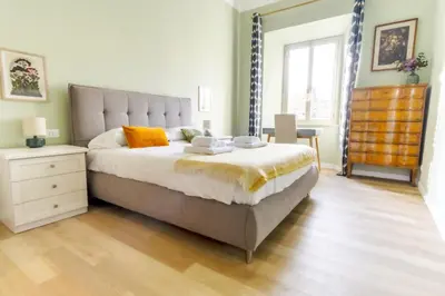 a bedroom with a large bed and a window at Elegantis La ParioLina Apartment in Rome