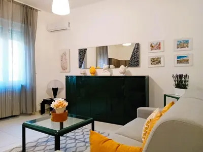 a living room with a couch and a table at BIBI San Giovanni Roma in Rome