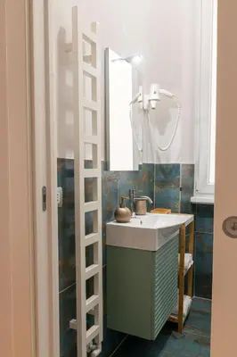 a bathroom with a sink and a mirror at MADI Collection Colosseum in Rome