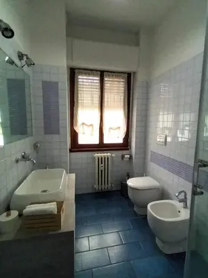 a bathroom with two sinks and a tub and a toilet at Casa verde di Mia in Rome