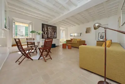 a living room with a bed and a table and chairs at Colosseo nei Fori Imperiali by Luxury Getaways in Rome