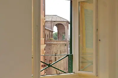 an open window with a view of the city at Colosseo nei Fori Imperiali by Luxury Getaways in Rome