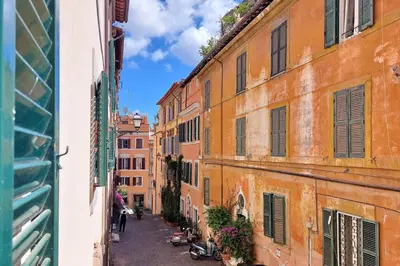 an alley in the city with buildings at Colosseo nei Fori Imperiali by Luxury Getaways in Rome