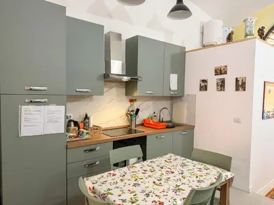 a kitchen with a table with chairs and a counter top at Nuovo monolocale a 15 minuti dalla Stazione Termini in Rome