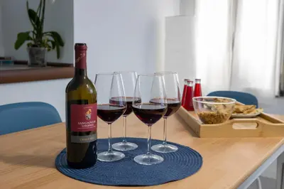 a bottle of wine and two glasses on a table at Roma 2 minuti a piedi dal Vaticano in Rome