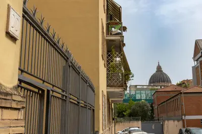 a building with a fence on a street at Roma 2 minuti a piedi dal Vaticano in Rome